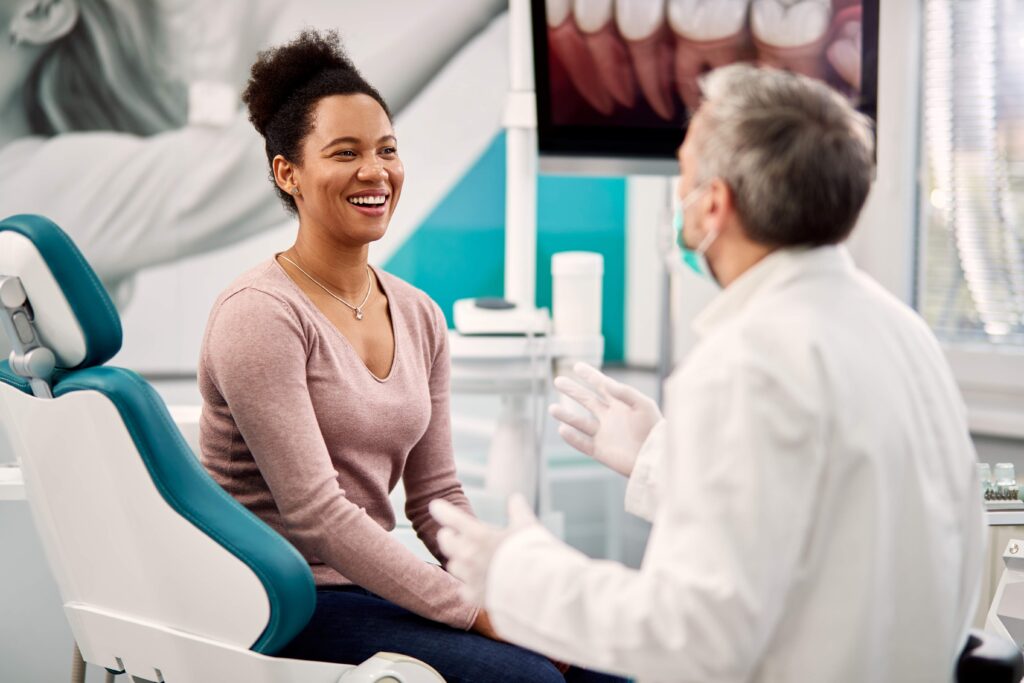 Smiling woman talking to dentist at appointment