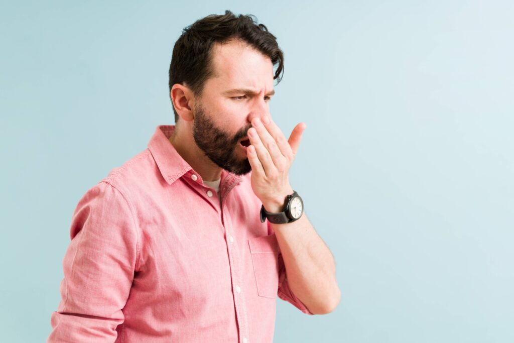 Closeup of man checking his breath